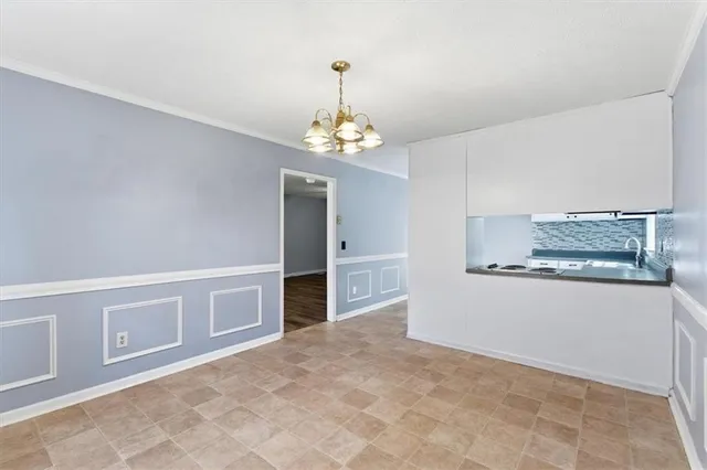 a view of a kitchen with microwave and refrigerator