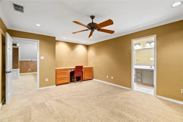 a view of a livingroom with a chandelier fan and windows