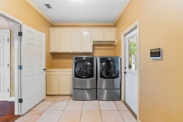 a utility room with wooden floor washer and dryer