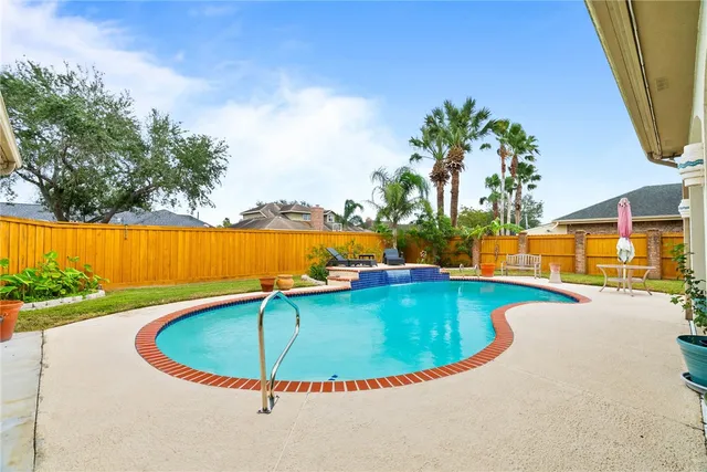 a view of a swimming pool with a yard