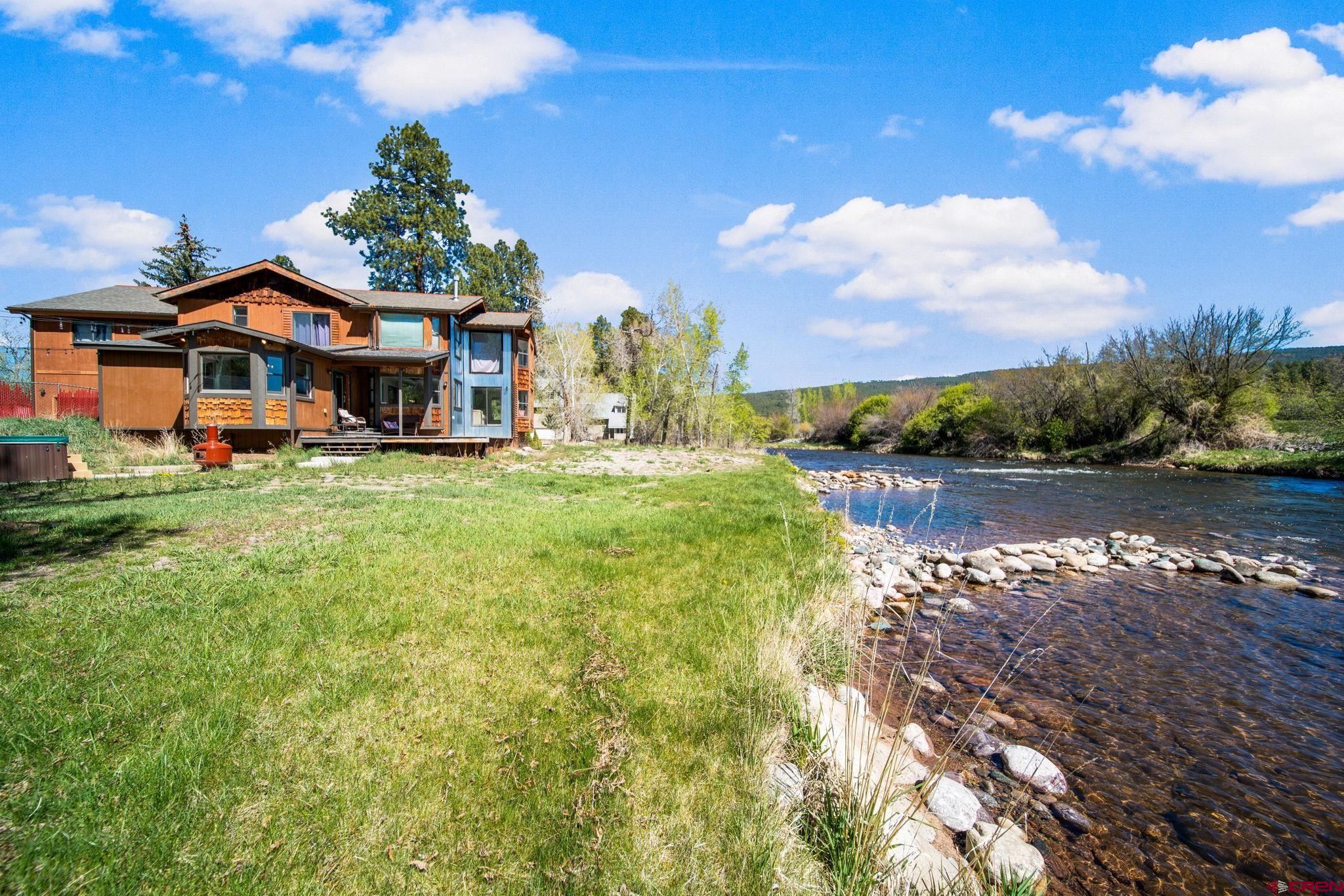 522 Pine River Ranch Circle Bayfield, CO 81122 - Photo 3 of 36 a view of a house with a yard and a fountain