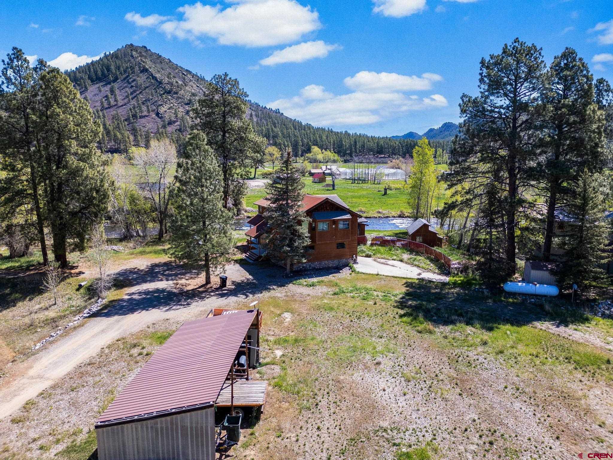 522 Pine River Ranch Circle Bayfield, CO 81122 - Photo 33 of 36 a view of a patio with a table chairs and a fire pit