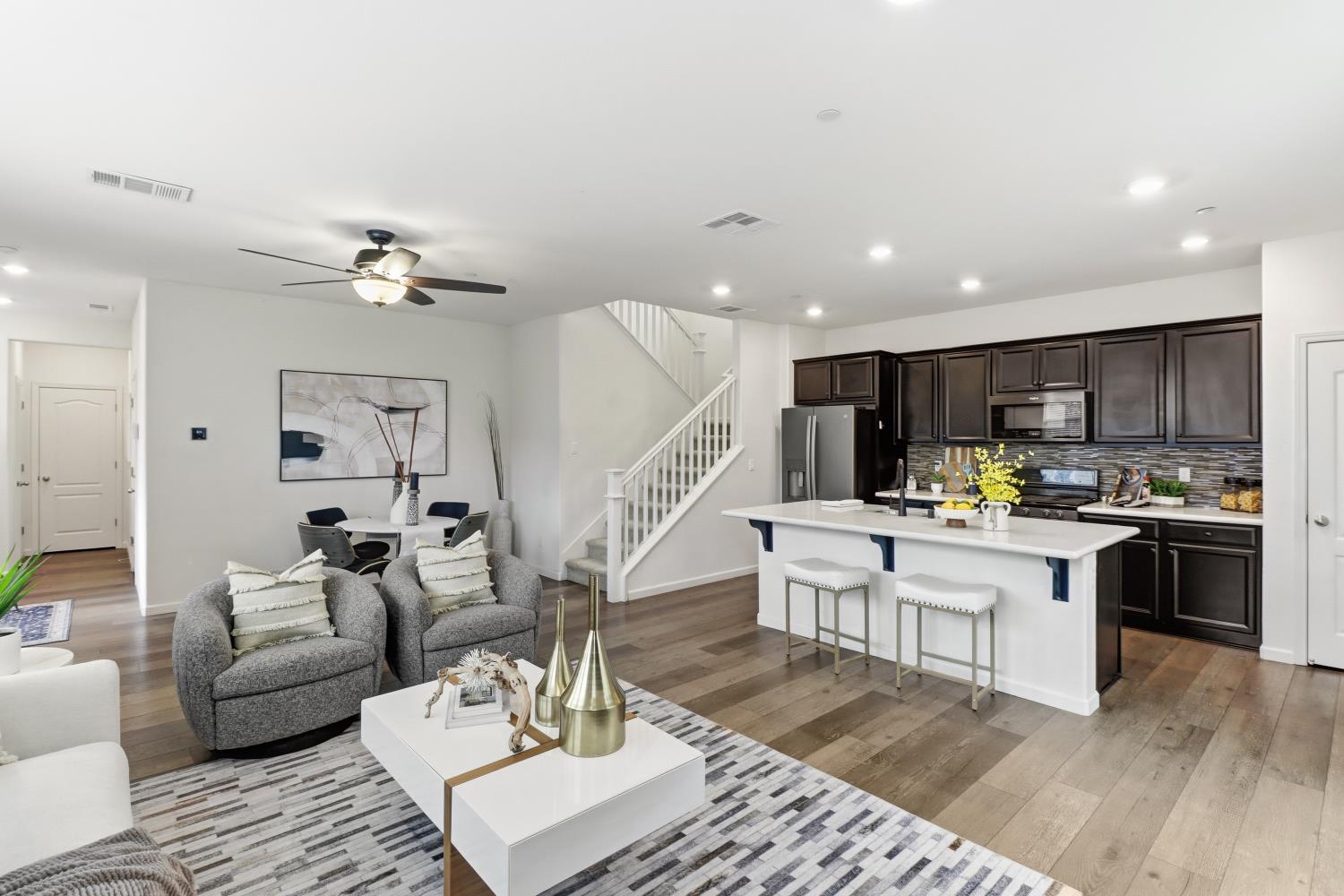 8900 Sheldon Terrace Lane Elk Grove, CA 95758 - Photo 11 of 57 a living room with furniture kitchen view and a wooden floor