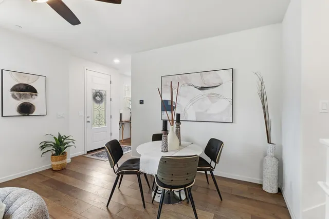 a living room with furniture kitchen view and a flat screen tv