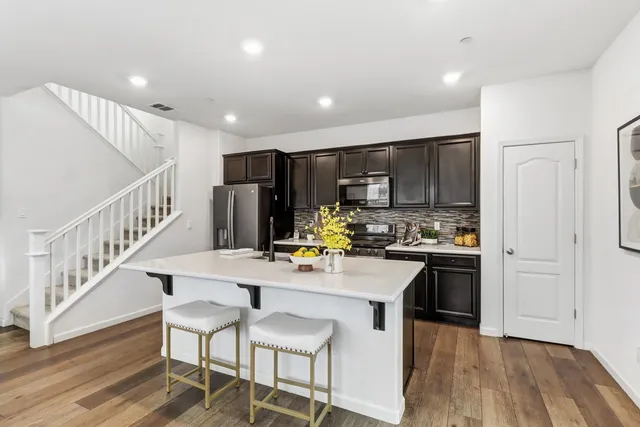 a kitchen with refrigerator and cabinets