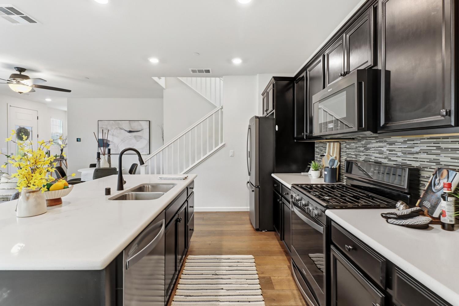 8900 Sheldon Terrace Lane Elk Grove, CA 95758 - Photo 23 of 57 a kitchen that has a sink and a stove