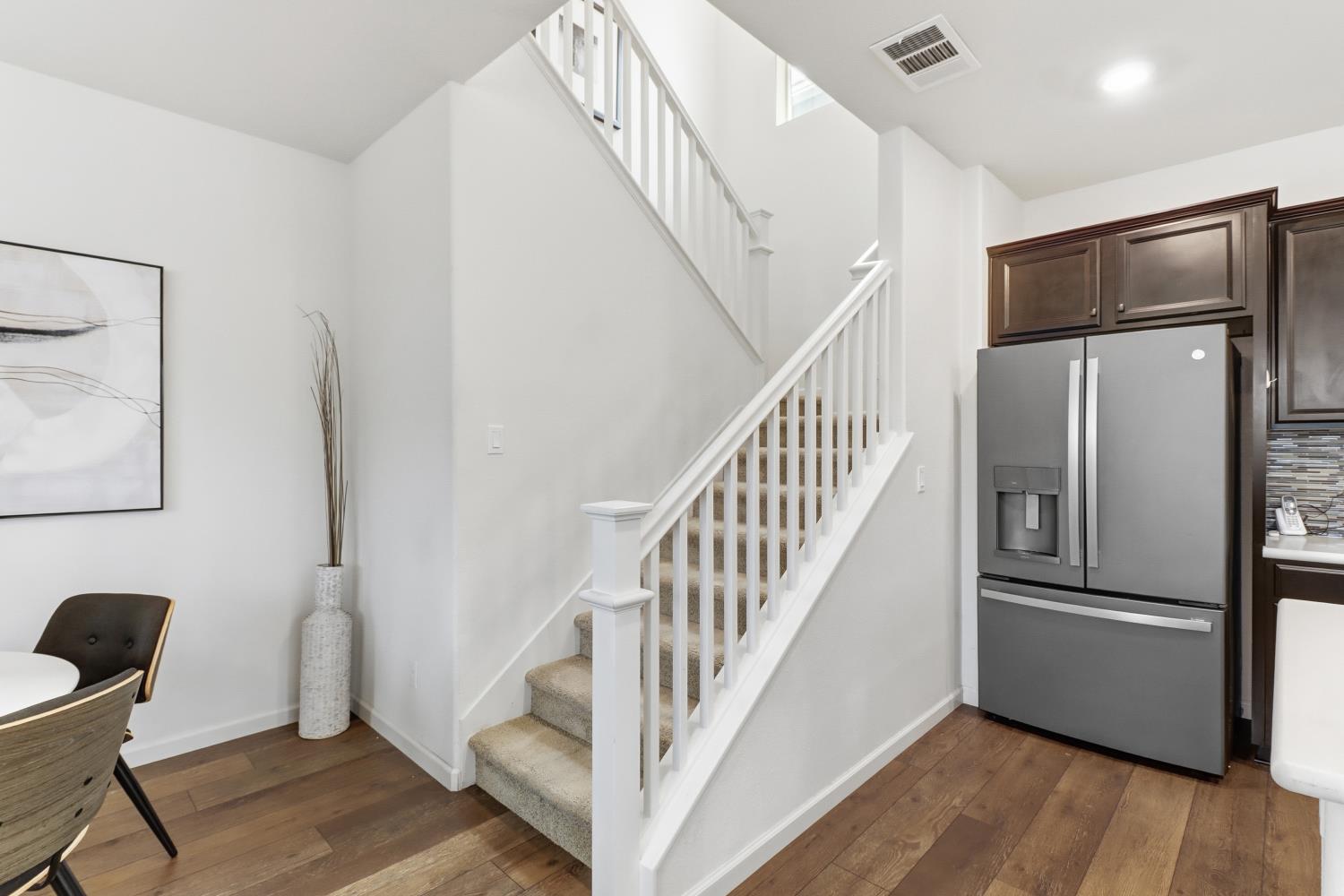 8900 Sheldon Terrace Lane Elk Grove, CA 95758 - Photo 24 of 57 a view of a hallway with wooden floor and staircase