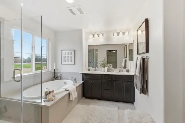 a white bath tub sitting in a bathroom next to a window