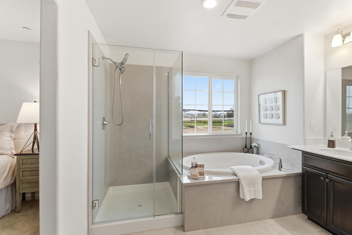 8900 Sheldon Terrace Lane Elk Grove, CA 95758 - Photo 32 of 57 a bathroom with a granite countertop bathtub sink vanity mirror and toilet