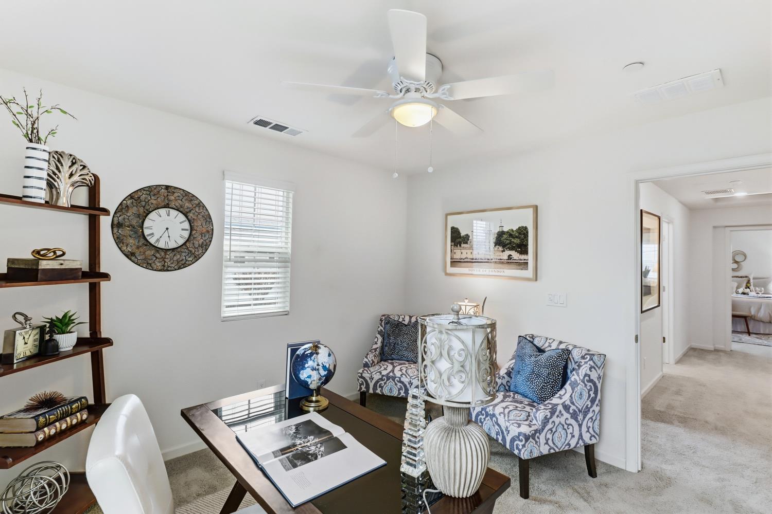 8900 Sheldon Terrace Lane Elk Grove, CA 95758 - Photo 37 of 57 a living room with couches a computer and a lamp on table with wooden floor