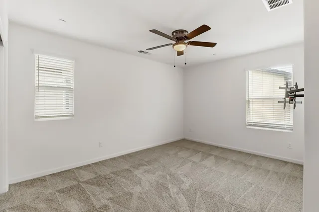 a backyard of a house with barbeque oven table and chairs