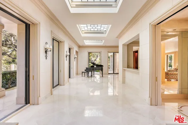 a view of a big room with chandelier windows and wooden floor