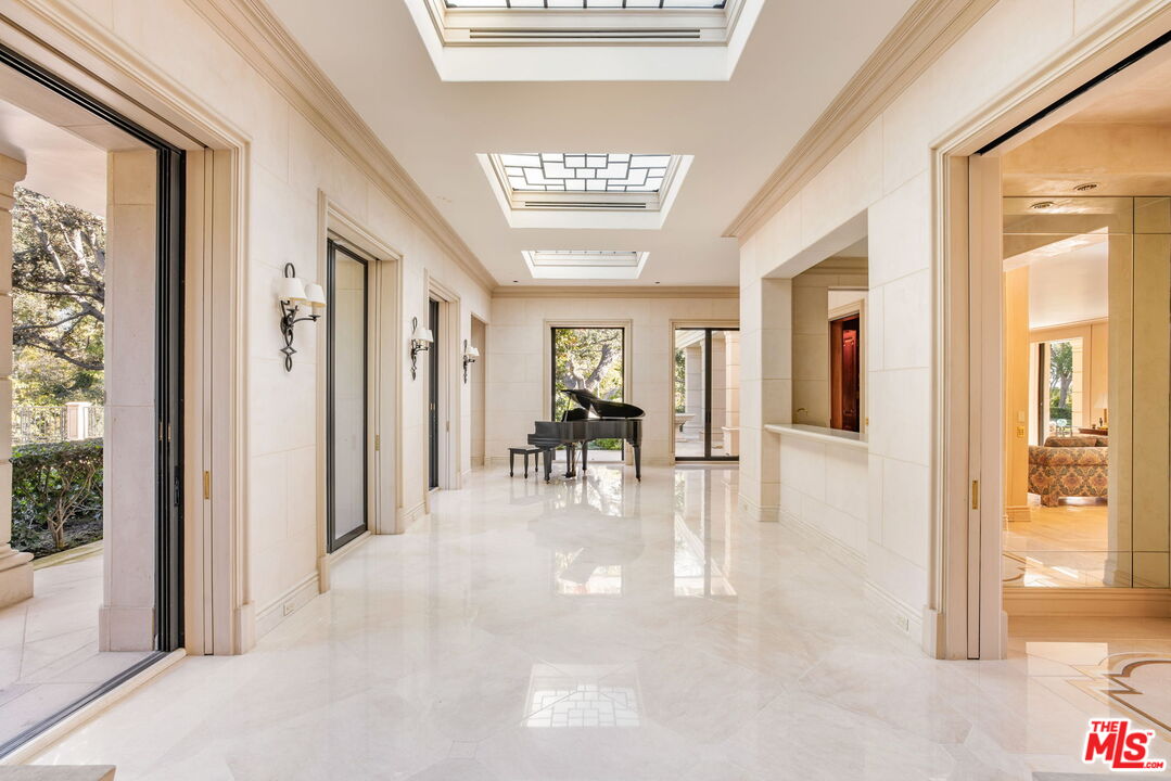 400 St Cloud Road Los Angeles, CA 90077 - Photo 12 of 25 a view of a big room with chandelier windows and wooden floor