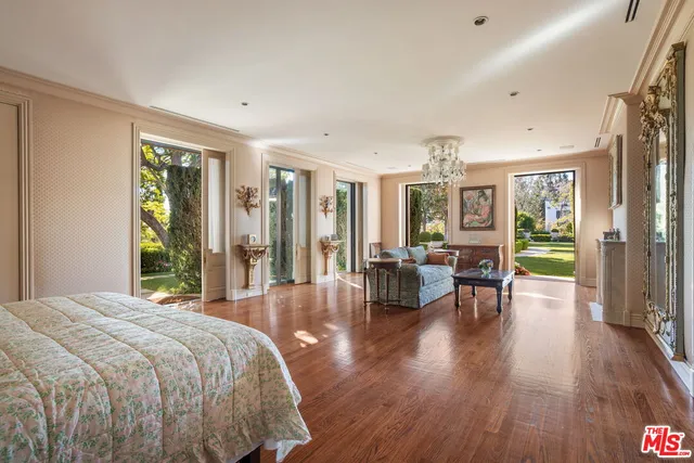 a spacious bedroom with a large bed and a large window