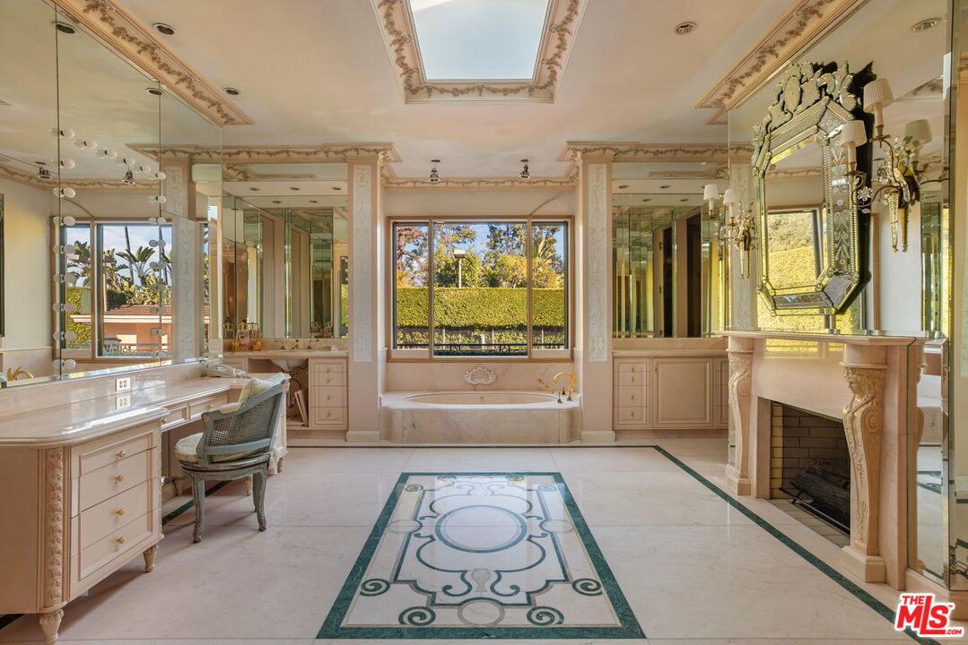 400 St Cloud Road Los Angeles, CA 90077 - Photo 19 of 25 a living room with furniture a fireplace and a flat screen tv