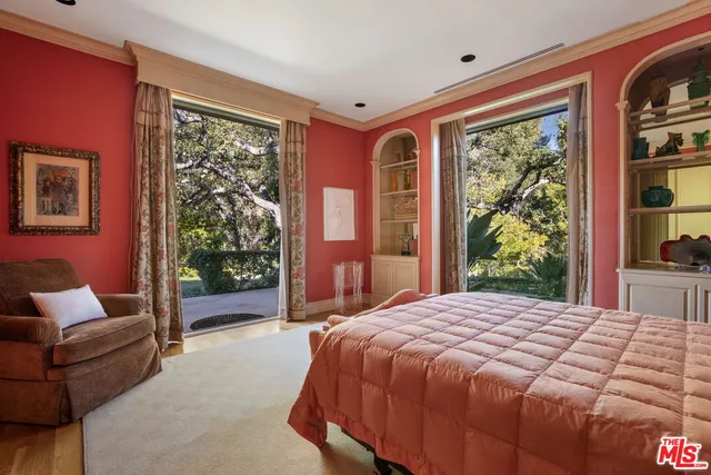 a bedroom with a large bed and a large window