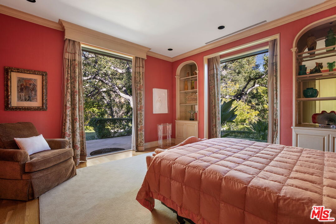 400 St Cloud Road Los Angeles, CA 90077 - Photo 20 of 25 a bedroom with a large bed and a large window