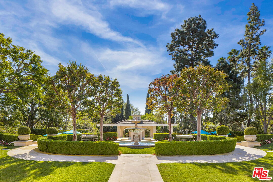 400 St Cloud Road Los Angeles, CA 90077 - Photo 2 of 25 a front view of a house with garden