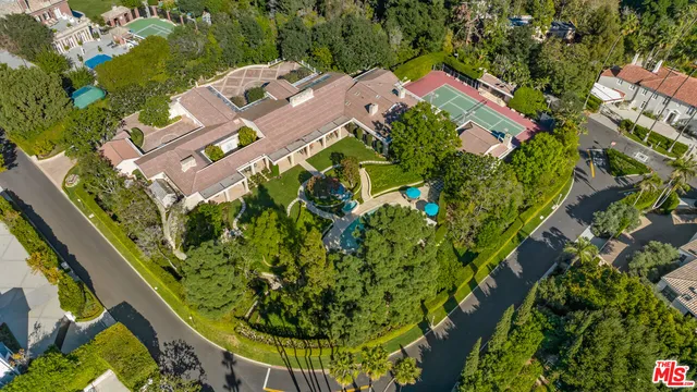 an aerial view of residential houses with outdoor space and street view
