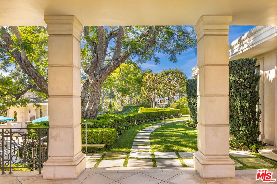 400 St Cloud Road Los Angeles, CA 90077 - Photo 9 of 25 a front view of a house with a yard