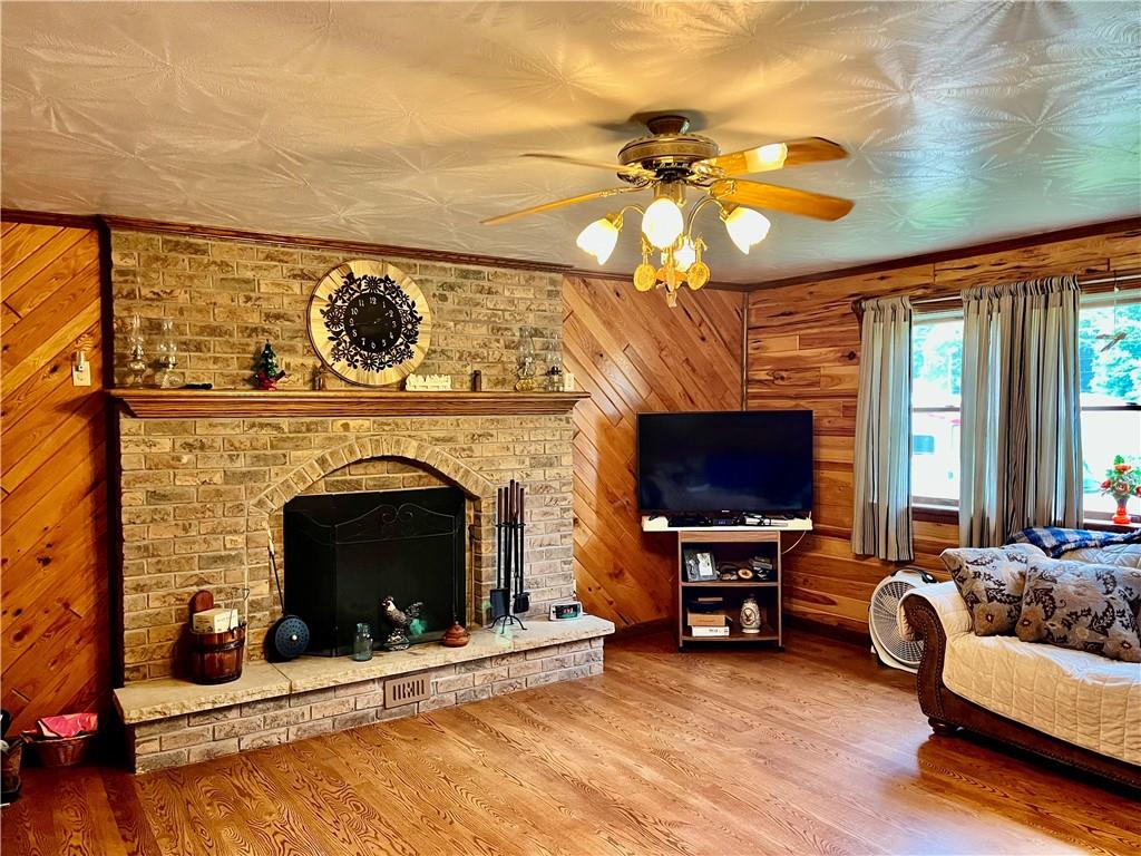 1316 Chicora Road Chicora, PA 16025 - Photo 12 of 25 a living room with furniture a fireplace and a flat screen tv