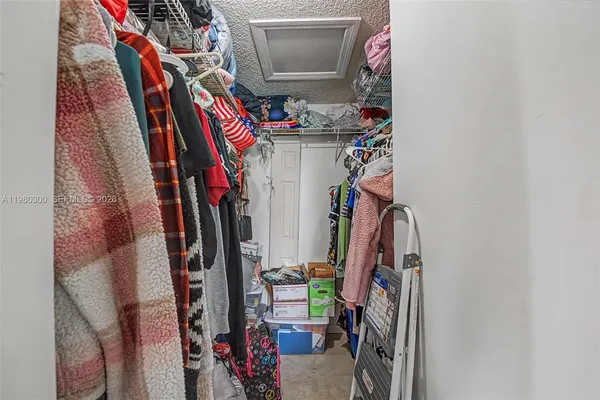 a view of walk in closet with clothes