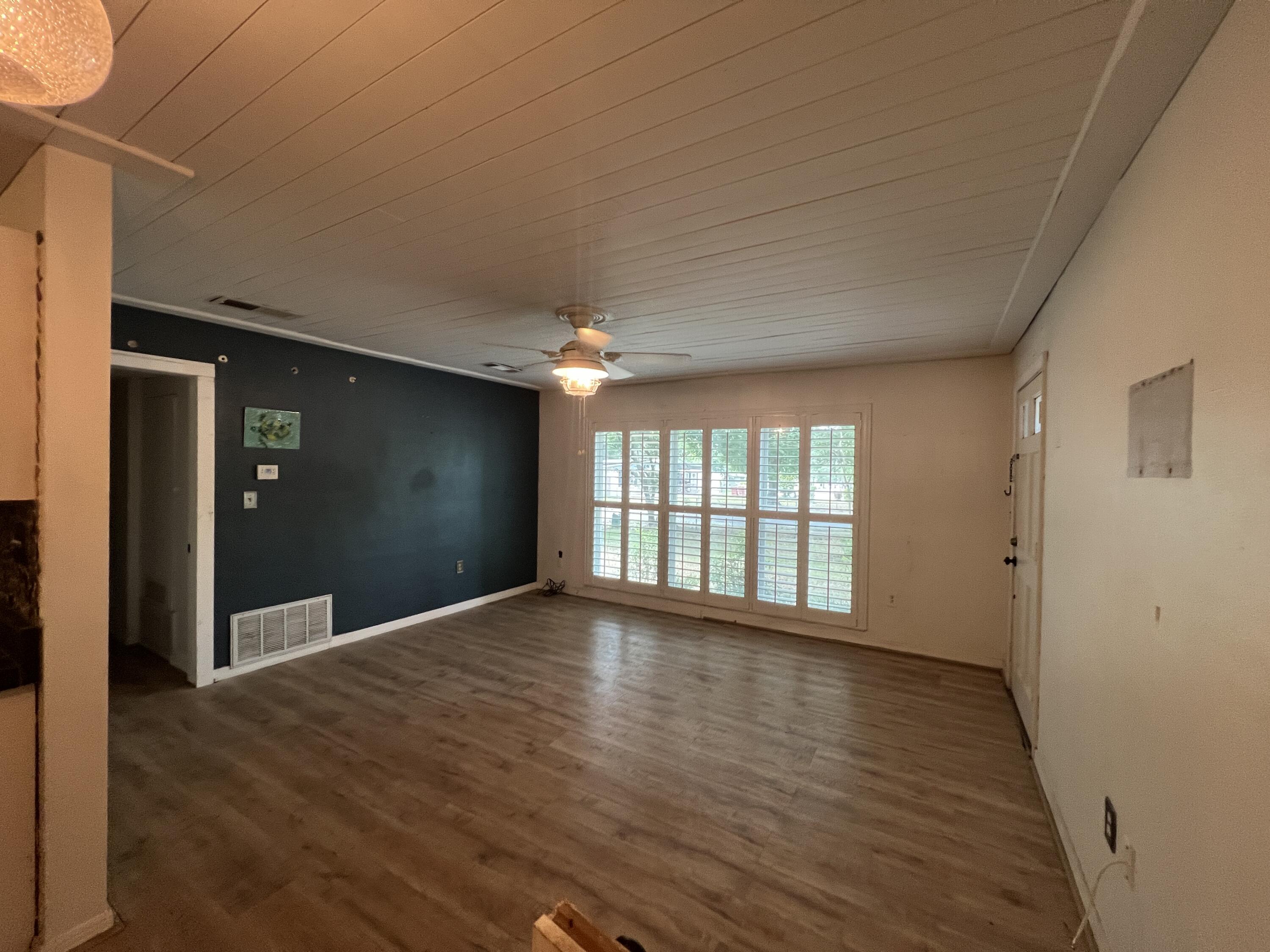 123 Panama Drive Crestview, FL 32536 - Photo 3 of 10 a view of an empty room with wooden floor and a window