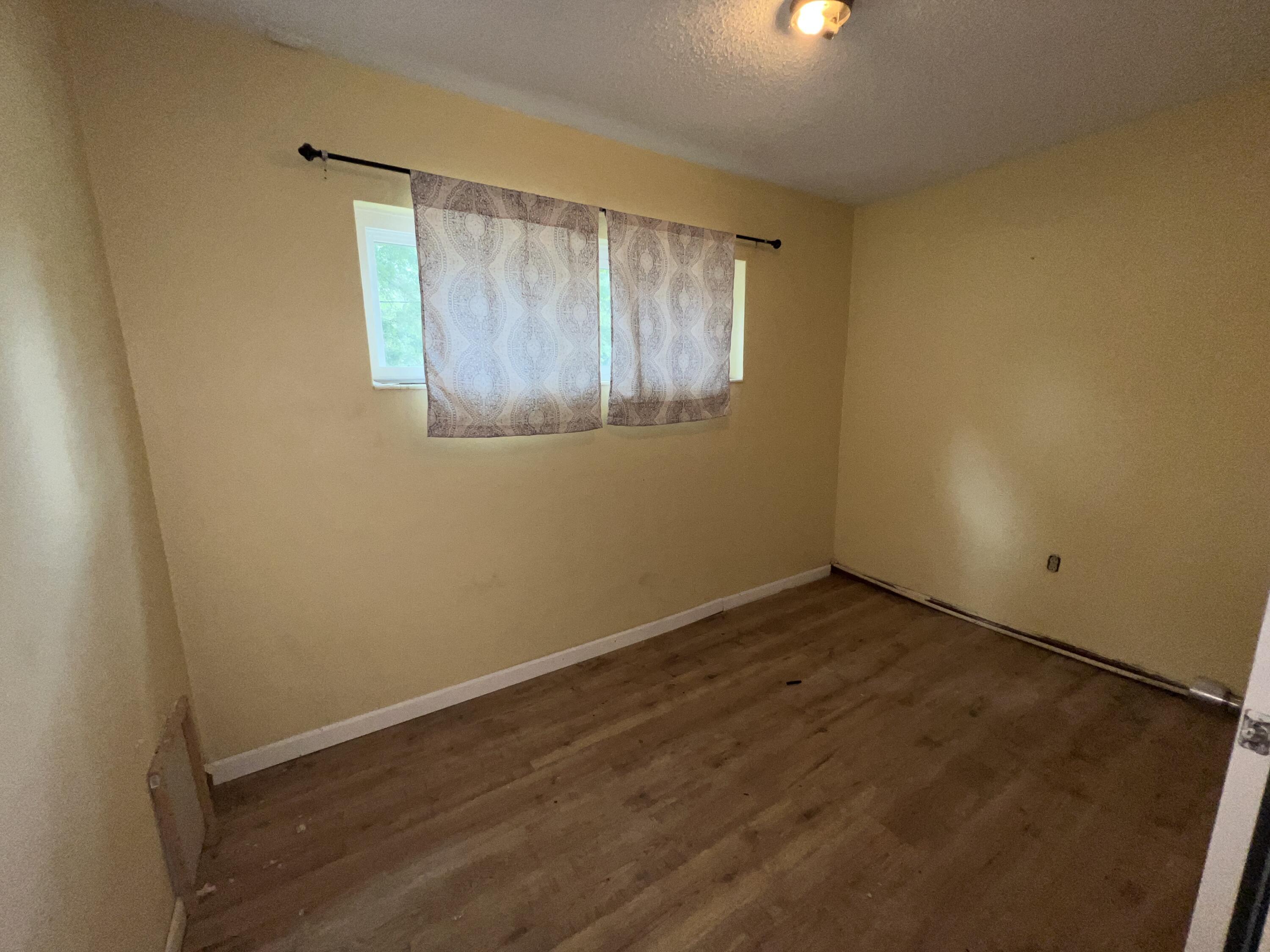 123 Panama Drive Crestview, FL 32536 - Photo 6 of 10 a view of an empty room with wooden floor and a window