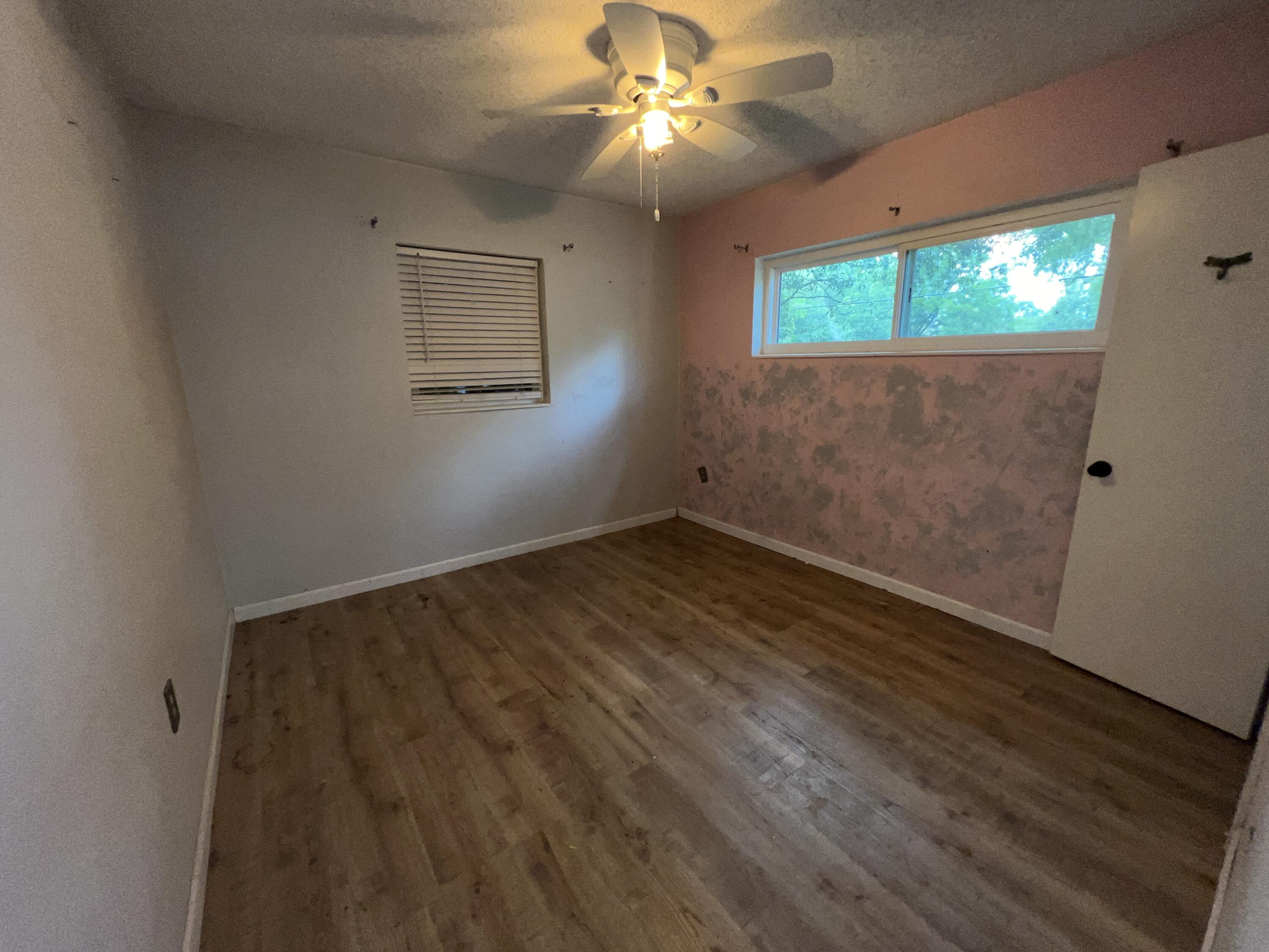 123 Panama Drive Crestview, FL 32536 - Photo 7 of 10 wooden floor in an empty room with a window