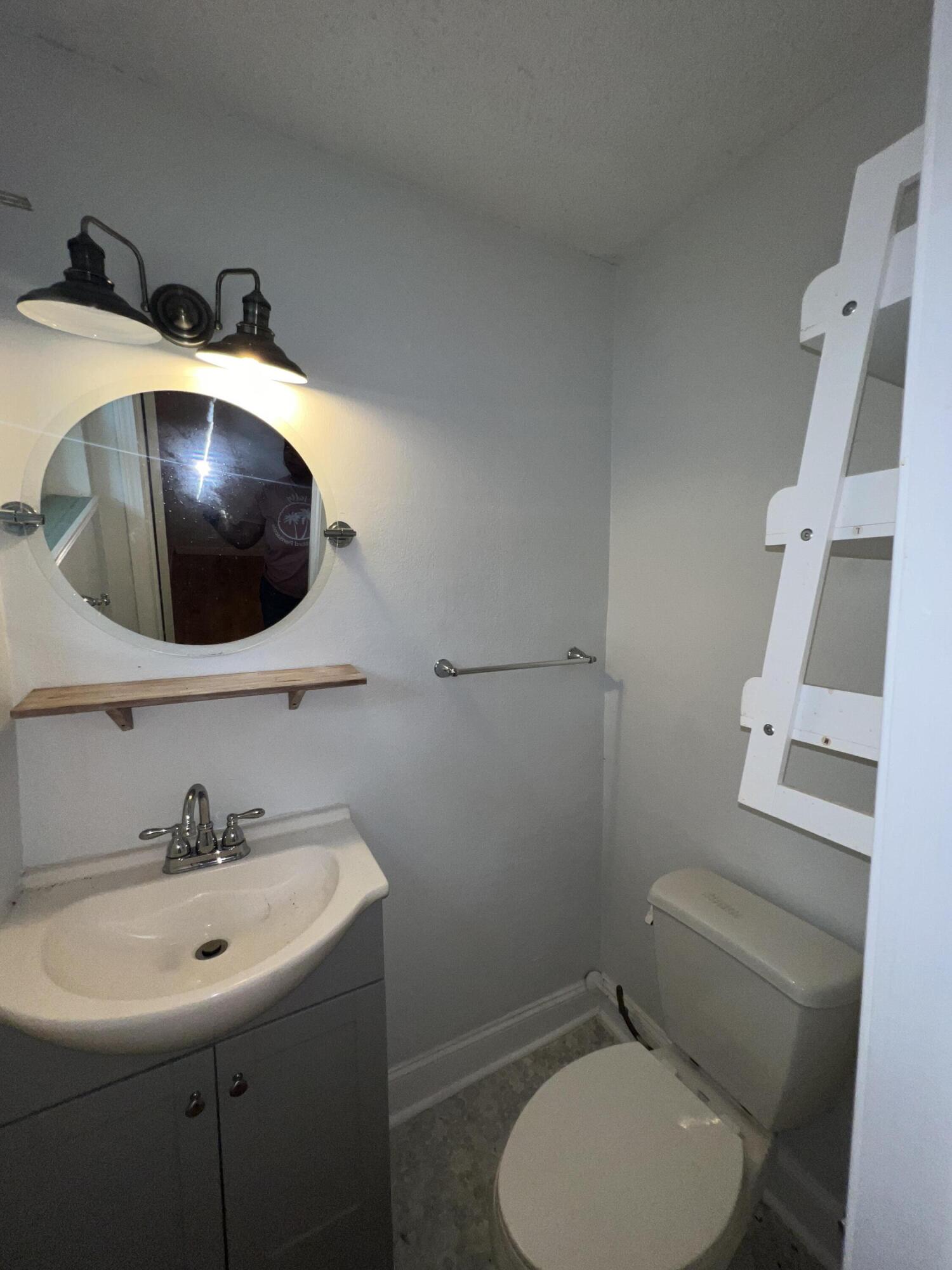 123 Panama Drive Crestview, FL 32536 - Photo 10 of 10 a bathroom with a toilet sink and mirror