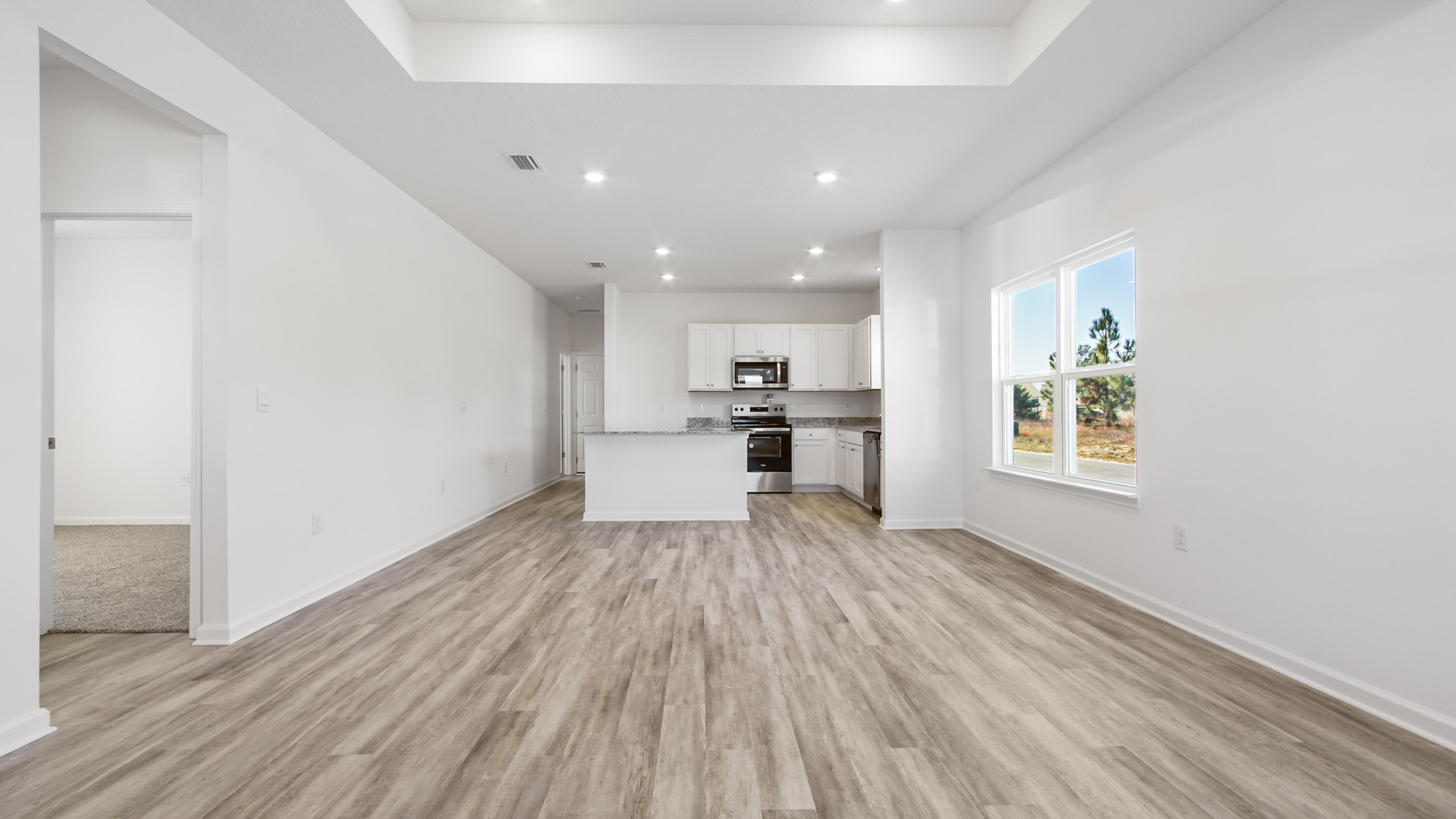 213 Huckleberry Street Freeport, FL 32439 - Photo 2 of 32 a view of kitchen with wooden floor electronic appliances and window