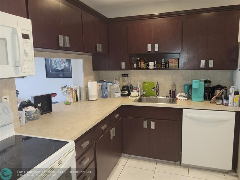 a kitchen with stainless steel appliances granite countertop a sink dishwasher stove and cabinets