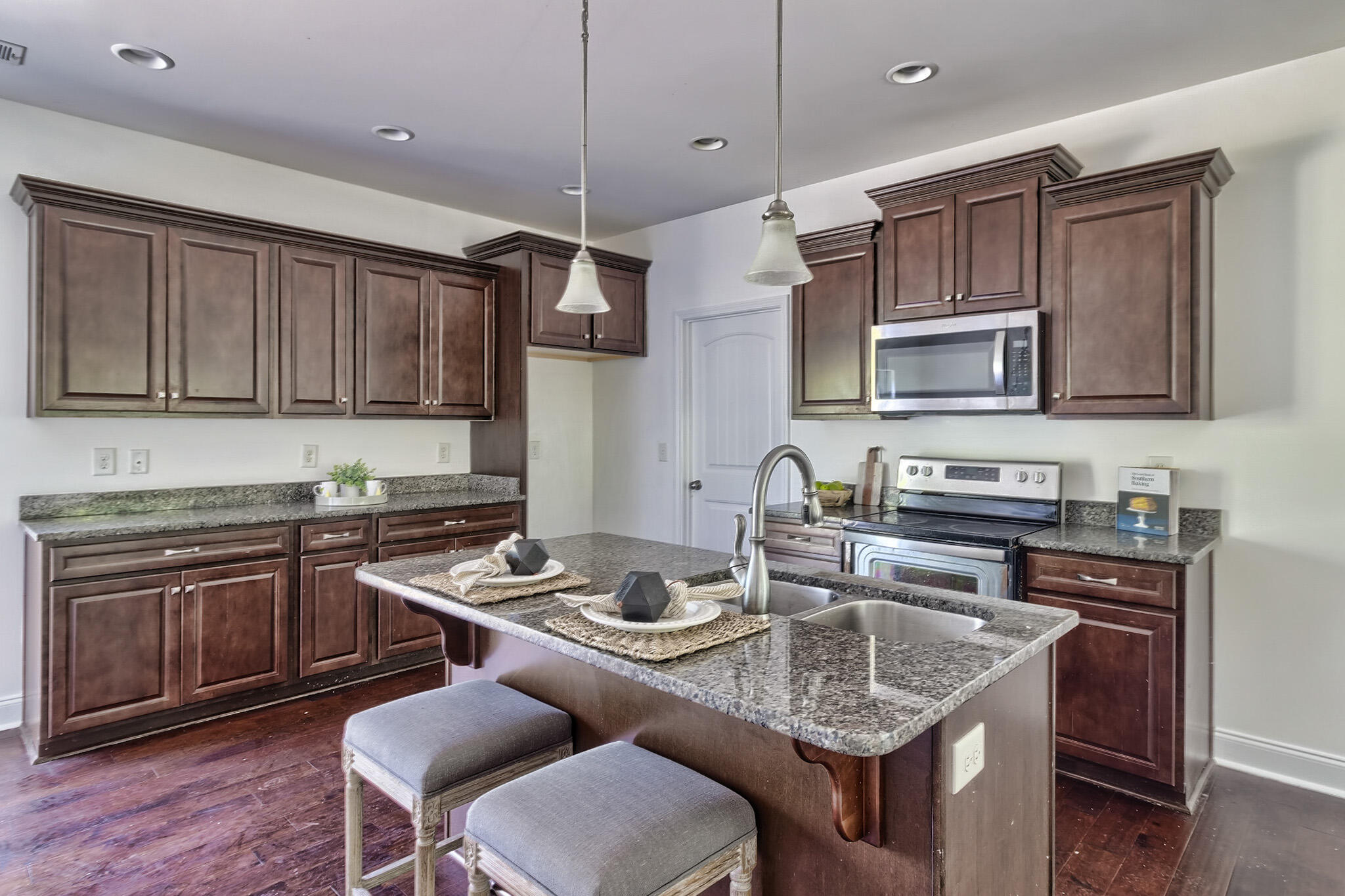 912 Goldie Road Leesville, SC 29070 - Photo 12 of 23 a kitchen with granite countertop a stove a sink a dining table and chairs
