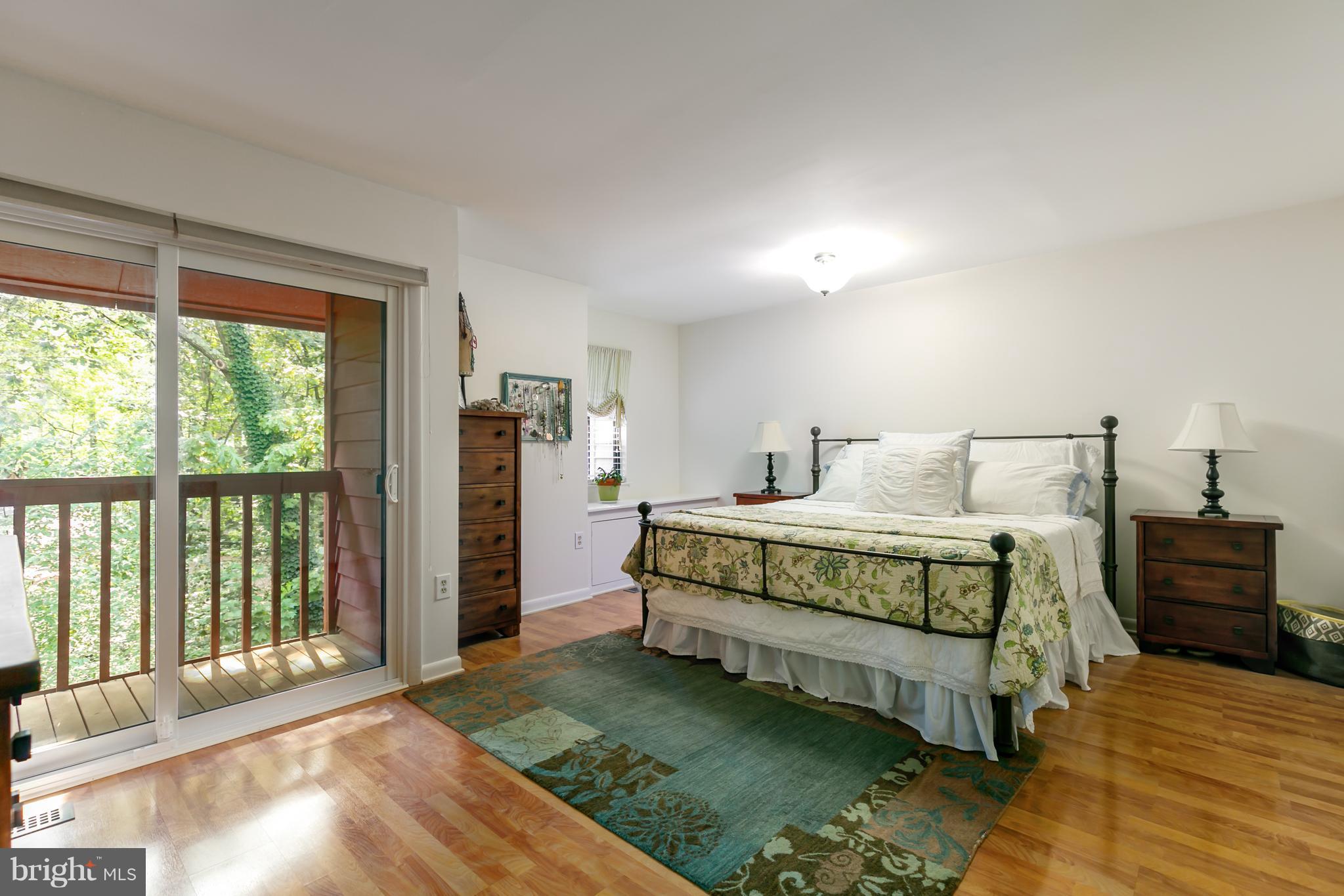1960 Winterport Cluster Reston, VA 20191 - Photo 12 of 29 a bedroom with a bed and a night stand