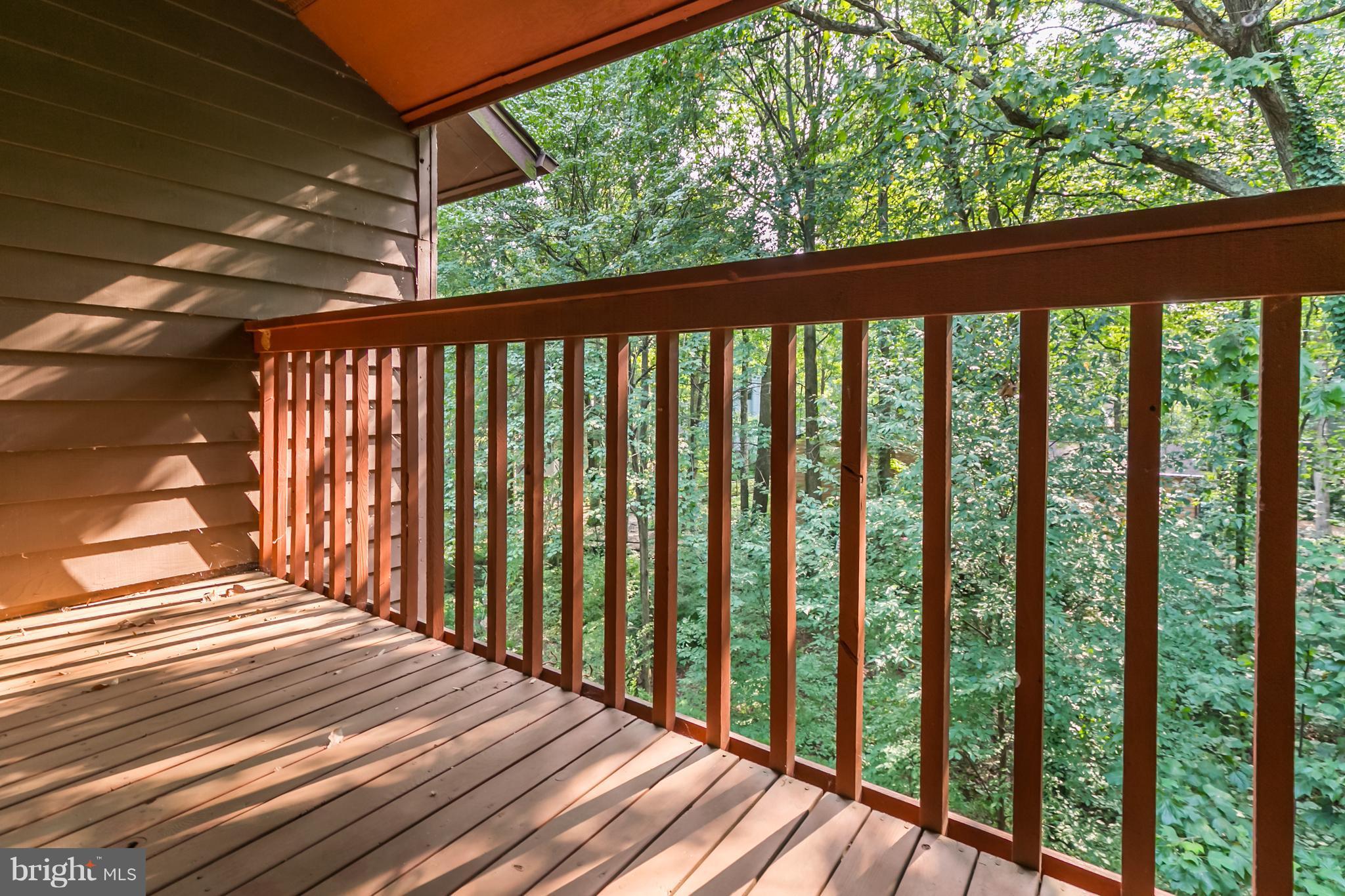 1960 Winterport Cluster Reston, VA 20191 - Photo 21 of 29 a view of a wooden balcony with a backyard