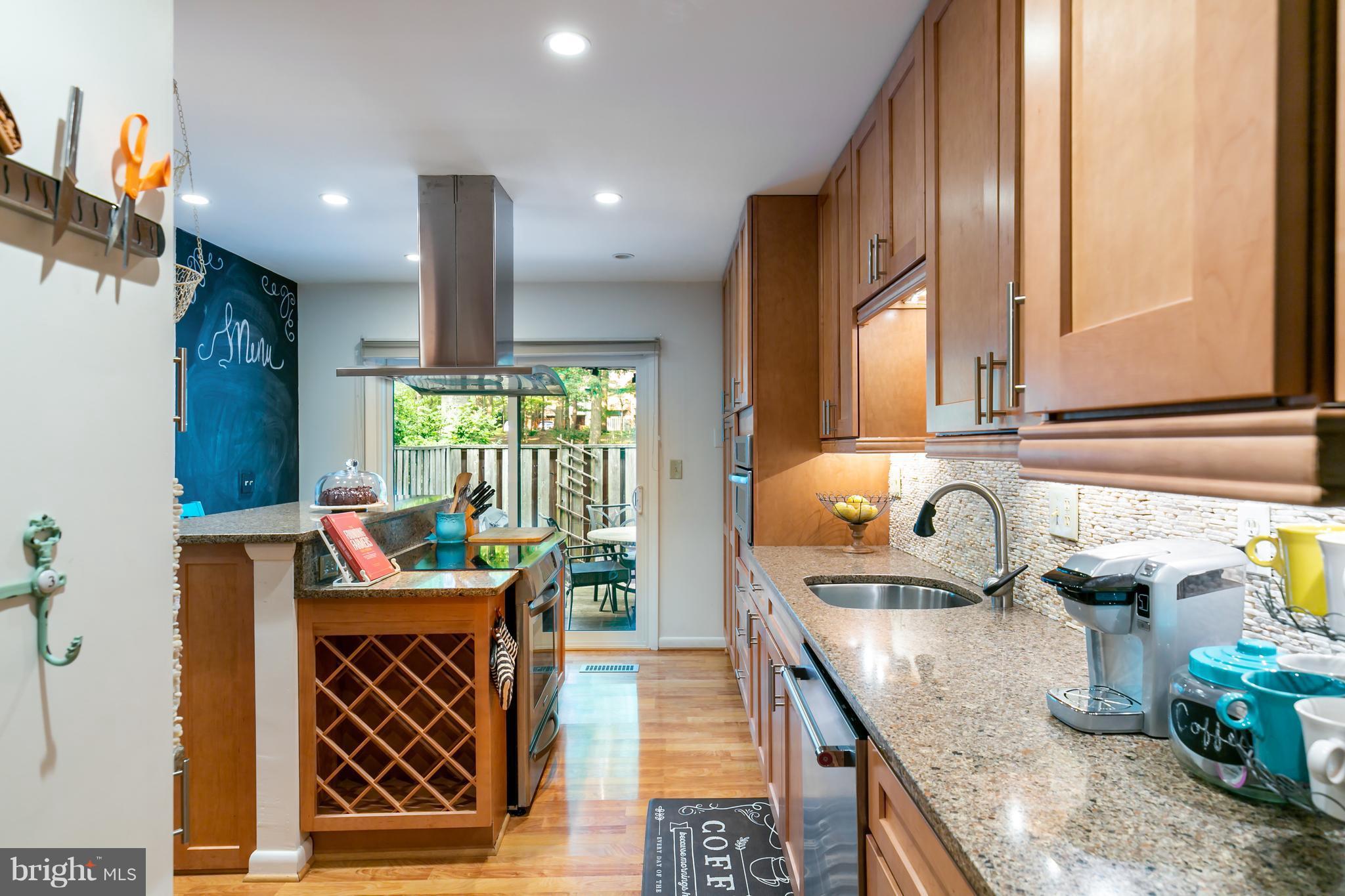 1960 Winterport Cluster Reston, VA 20191 - Photo 5 of 29 a kitchen with granite countertop a sink stove and cabinets