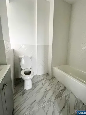 a bathroom with a toilet and a bathtub