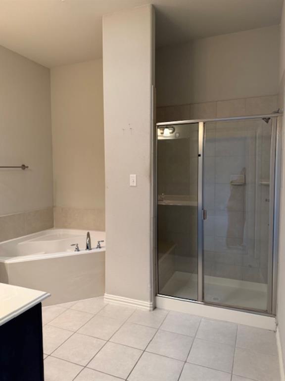 4119 Nia Drive Irving, TX 75038 - Photo 13 of 15 Bathroom with vanity, light tile patterned flooring, a bath, and a stall shower