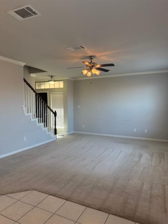 4119 Nia Drive Irving, TX 75038 - Photo 3 of 15 Unfurnished living room with light carpet, light tile patterned floors, stairway, and crown molding