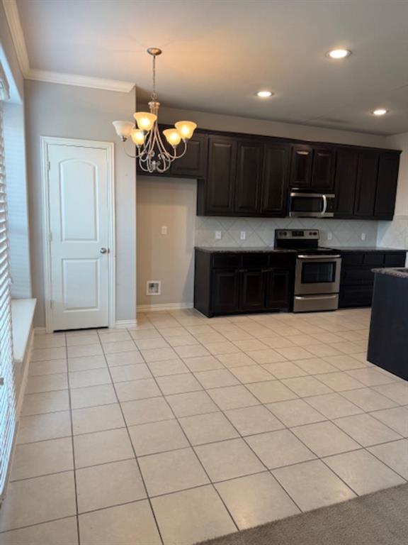 4119 Nia Drive Irving, TX 75038 - Photo 5 of 15 Kitchen with light tile patterned floors, stove, backsplash, crown molding, and recessed lighting