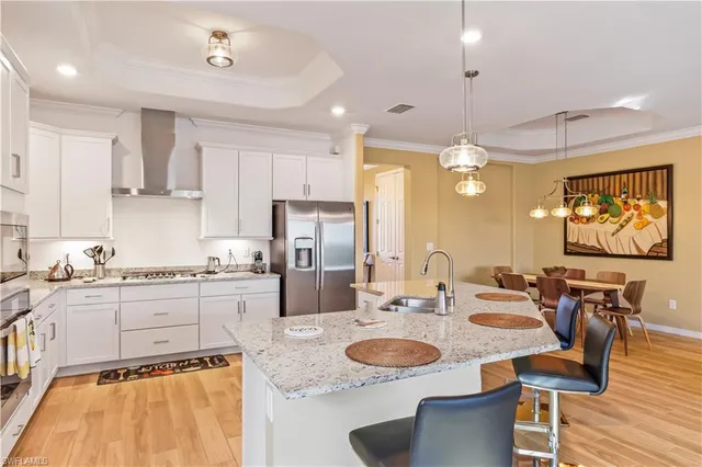 a large kitchen with kitchen island a sink table and chairs
