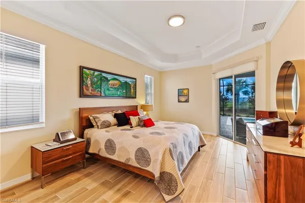 a bedroom with bed and a large window