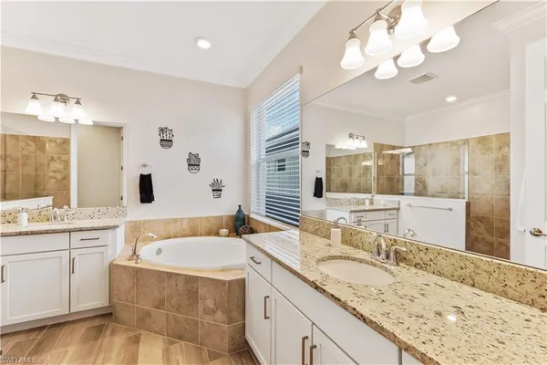 a bathroom with a granite countertop sink and a large mirror