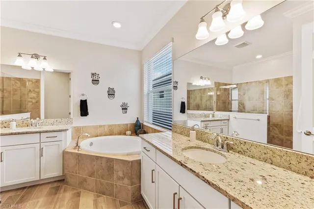 a bathroom with a granite countertop sink and a large mirror