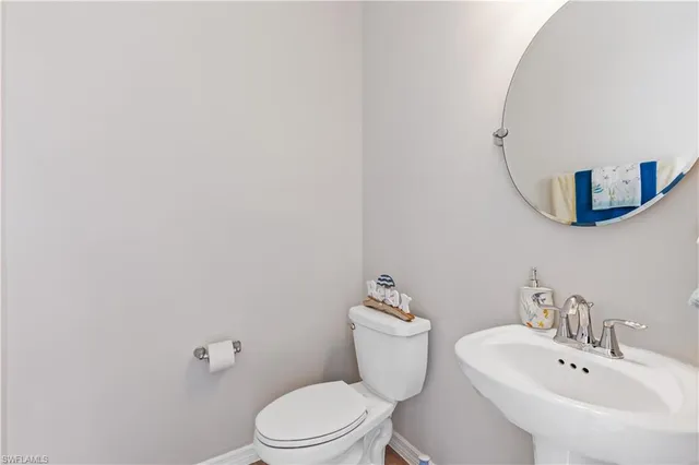 a white toilet sitting next to a bathroom sink