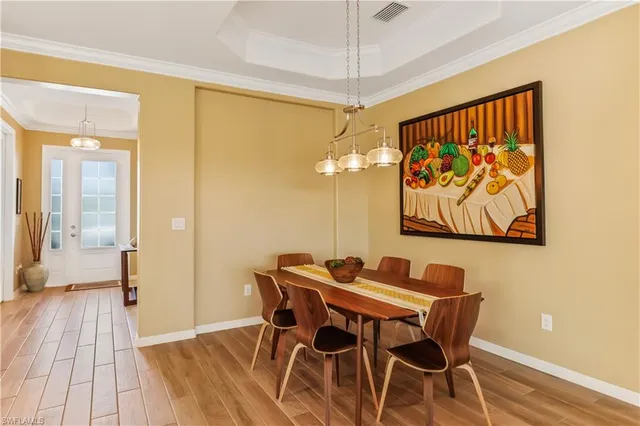 a view of a dining room with furniture wooden floor and a chandelier