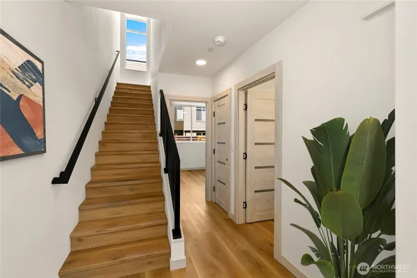 a view of entryway with wooden floor and stairs