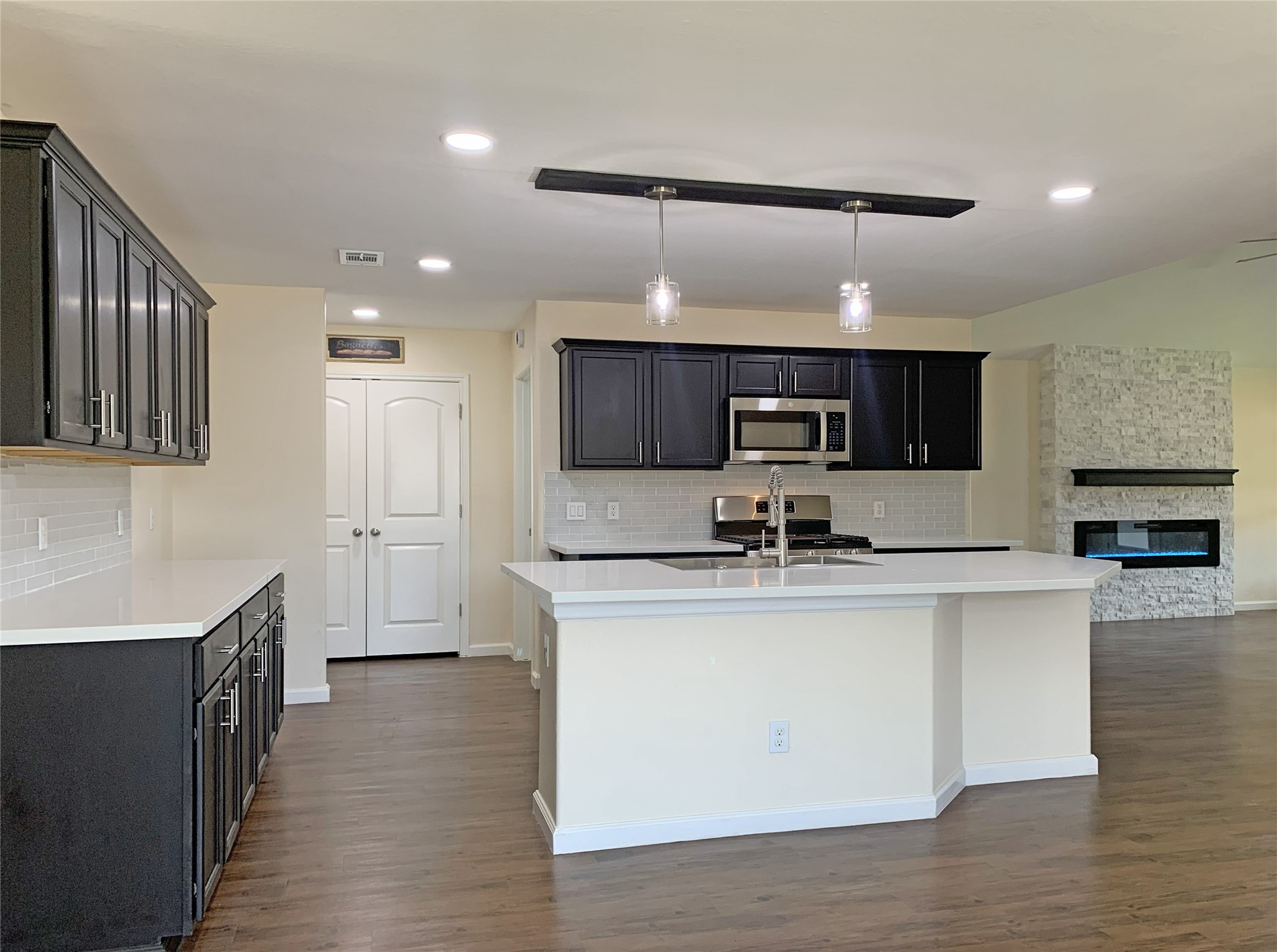 5612 Rainflower Terrace Lane Spring, TX 77389 - Photo 7 of 50 a kitchen with stainless steel appliances a sink and a stove top oven