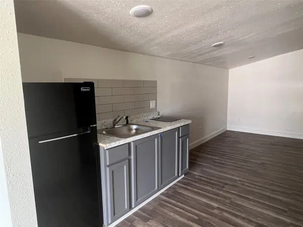 a kitchen with a refrigerator and a sink