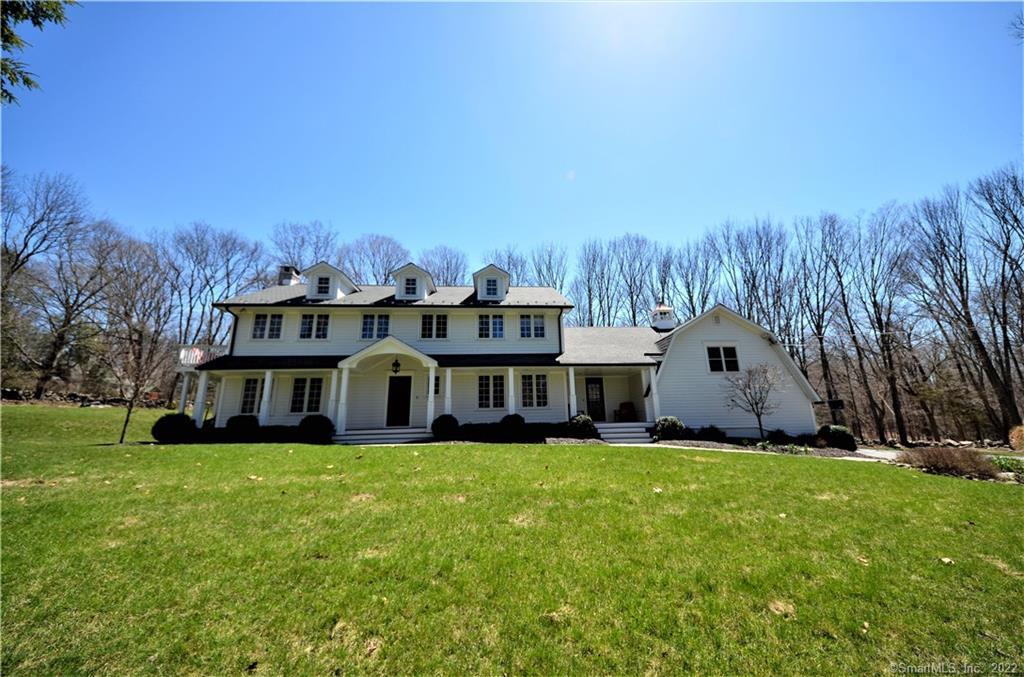 107 Lyons Plain Road Weston, CT 06883 - Photo 1 of 1 a view of a house with a big yard and large trees